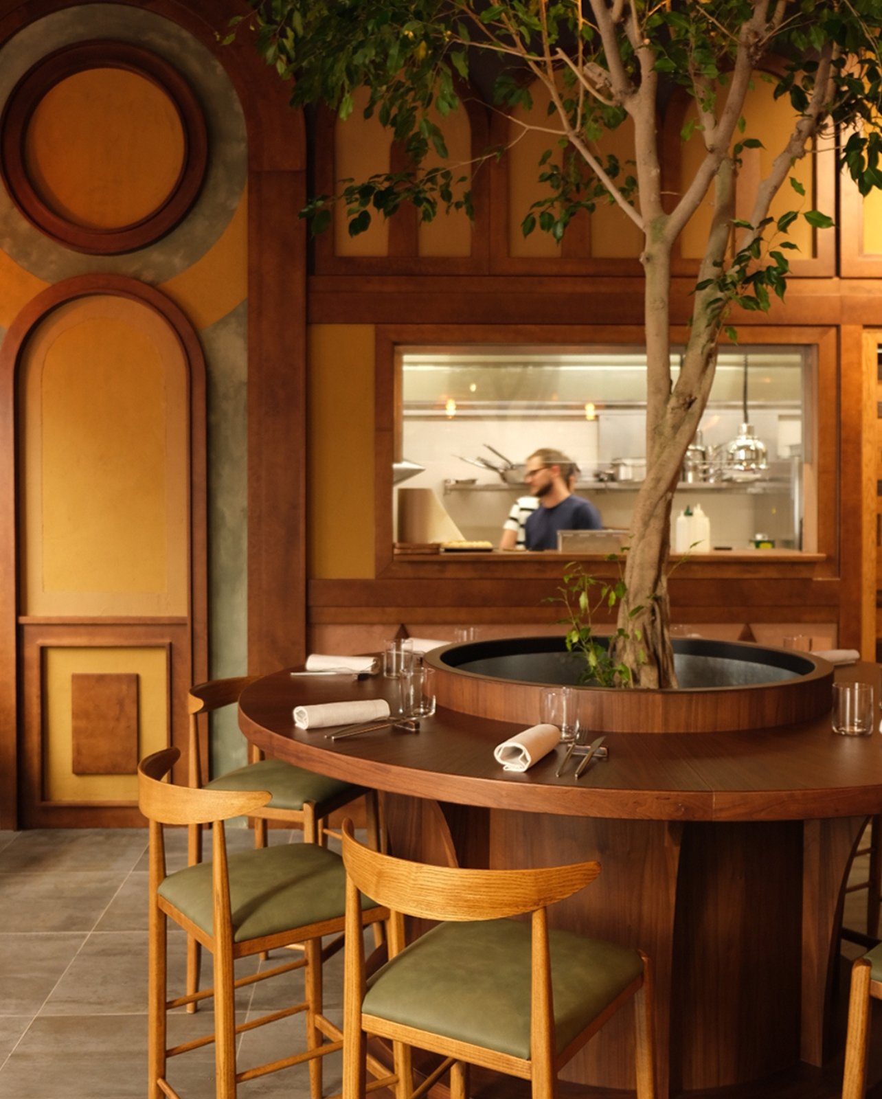 Bacán restaurant interior setup with tree in the middle of table