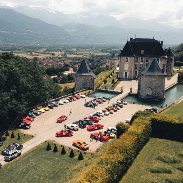 Rows of vintage cars parked in front of a castle for the Rallye des Princesses Richard Mille event