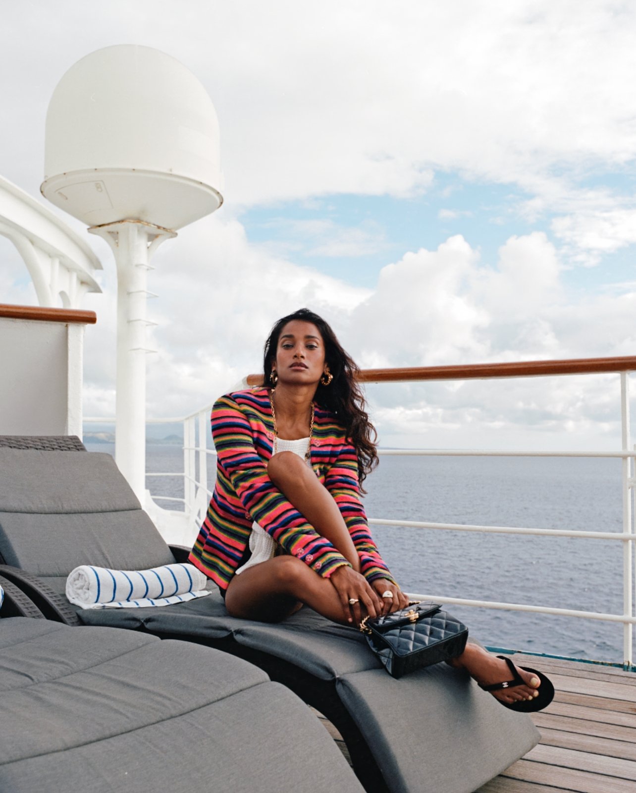 Model wearing Chanel on Windstar Cruises’ Wind Spirit sitting on lounge chair