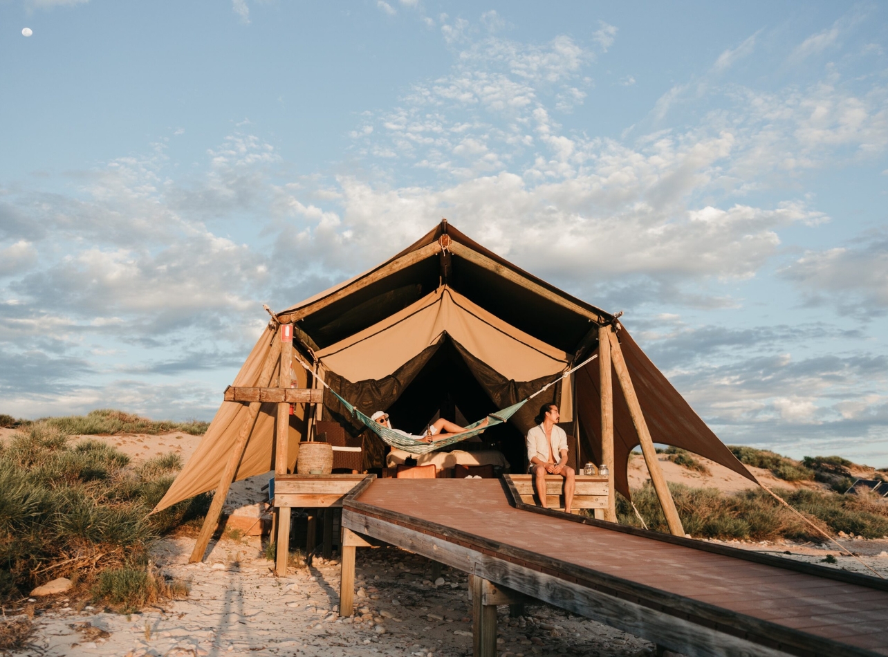 Ningaloo Reef tent with one person in hammock and another sitting on the edge