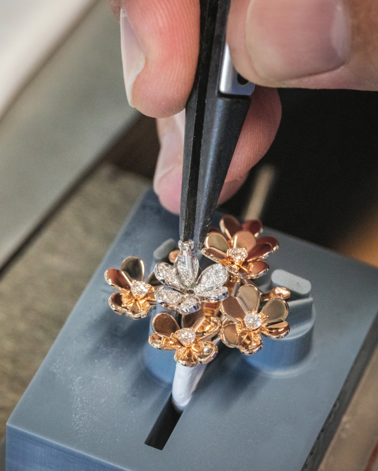 Van Cleef & Arpels jeweler setting diamond in ring