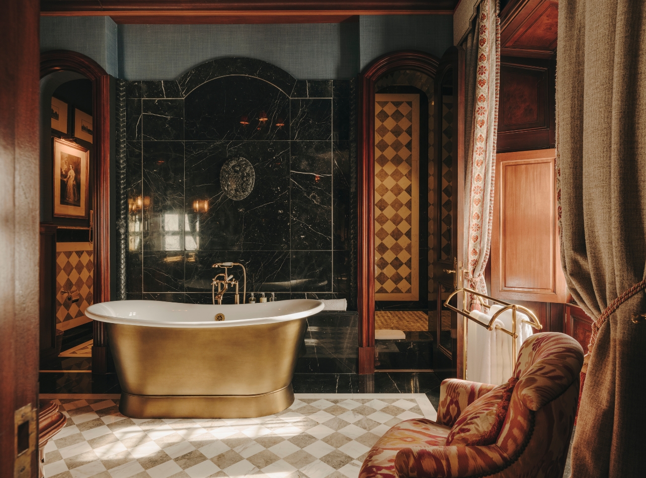 Bathroom with golden tub at Grand Hotel Son Net