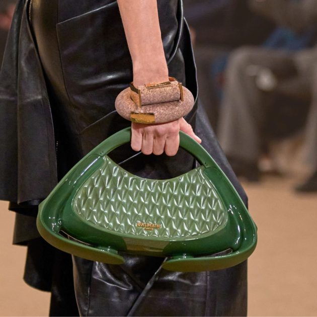 Balmain green bag carried by model from Fall/Winter collection runway