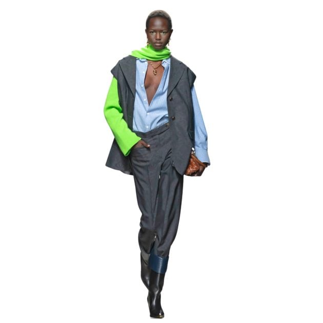 Etro model in fall winter collection wearing gray pants and blue long sleeve button down and green scarf