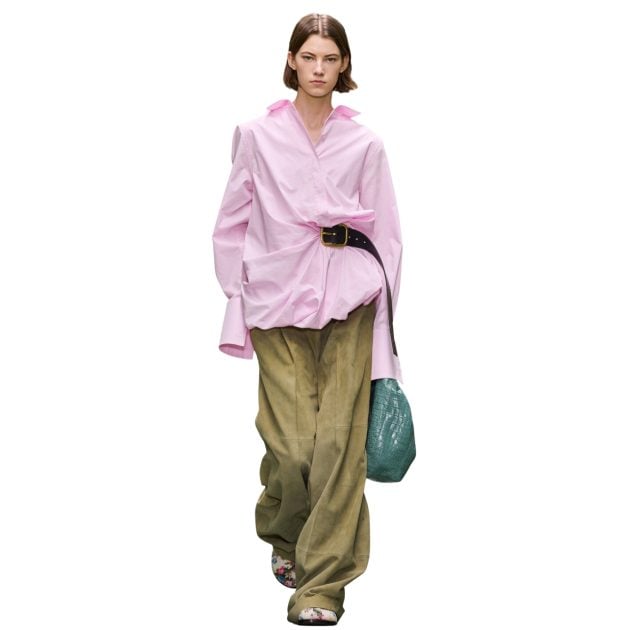 Loewe model wearing pink long sleeve top with attached belt and green suede pants