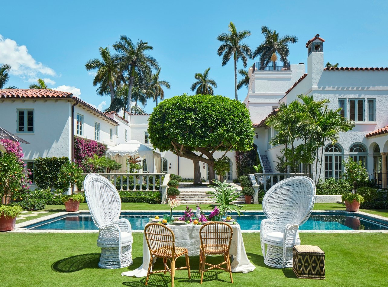 Table and chairs outside in front of a pool