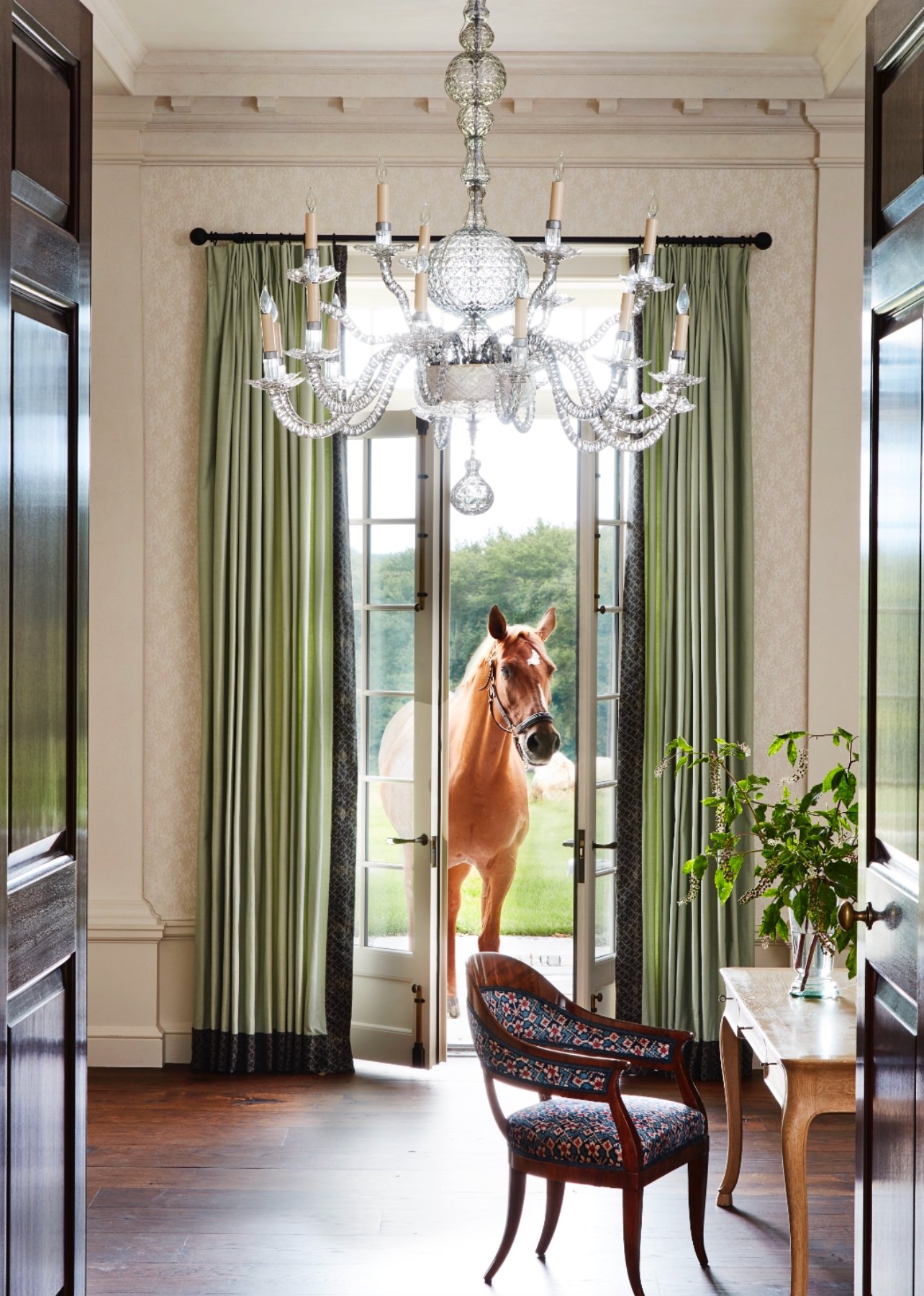 Living room in a formal house with a horse in the window