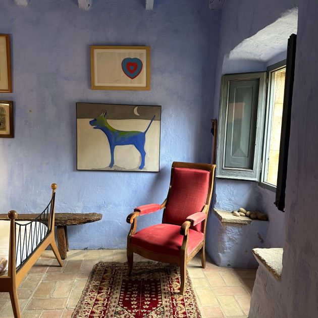 Blue painted room with red chair in the corner