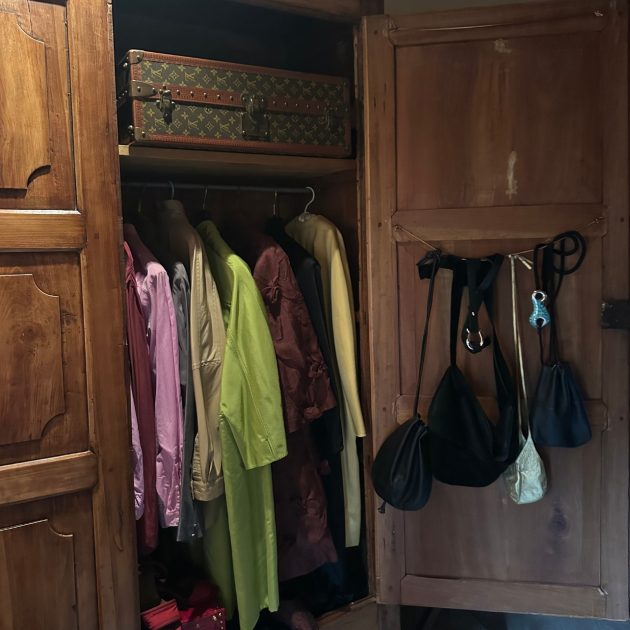 Closet with clothes hanging inside