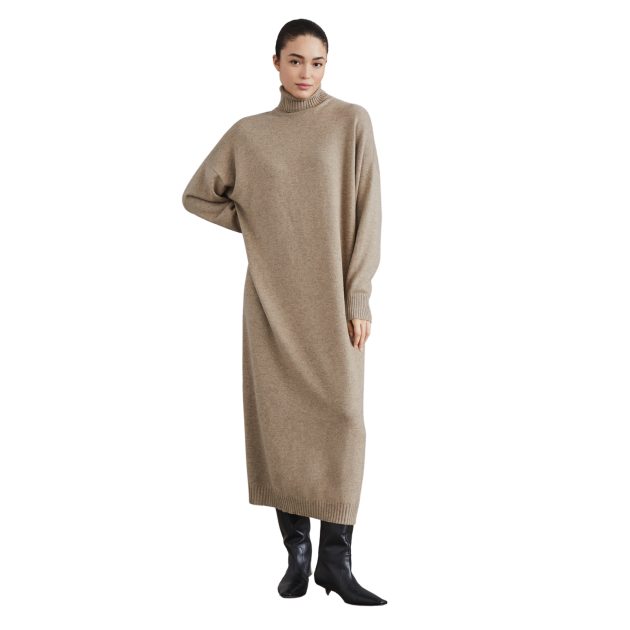 Brunello Cucinelli model wearing a turtleneck long sleeve beige dress and black boots