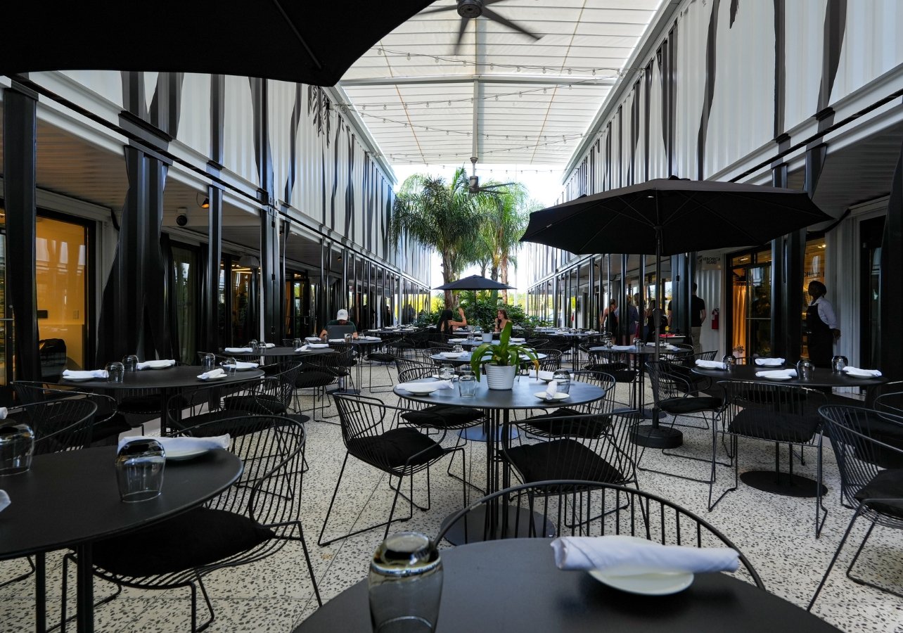 Outdoor seating area of “The Whitman” restaurant