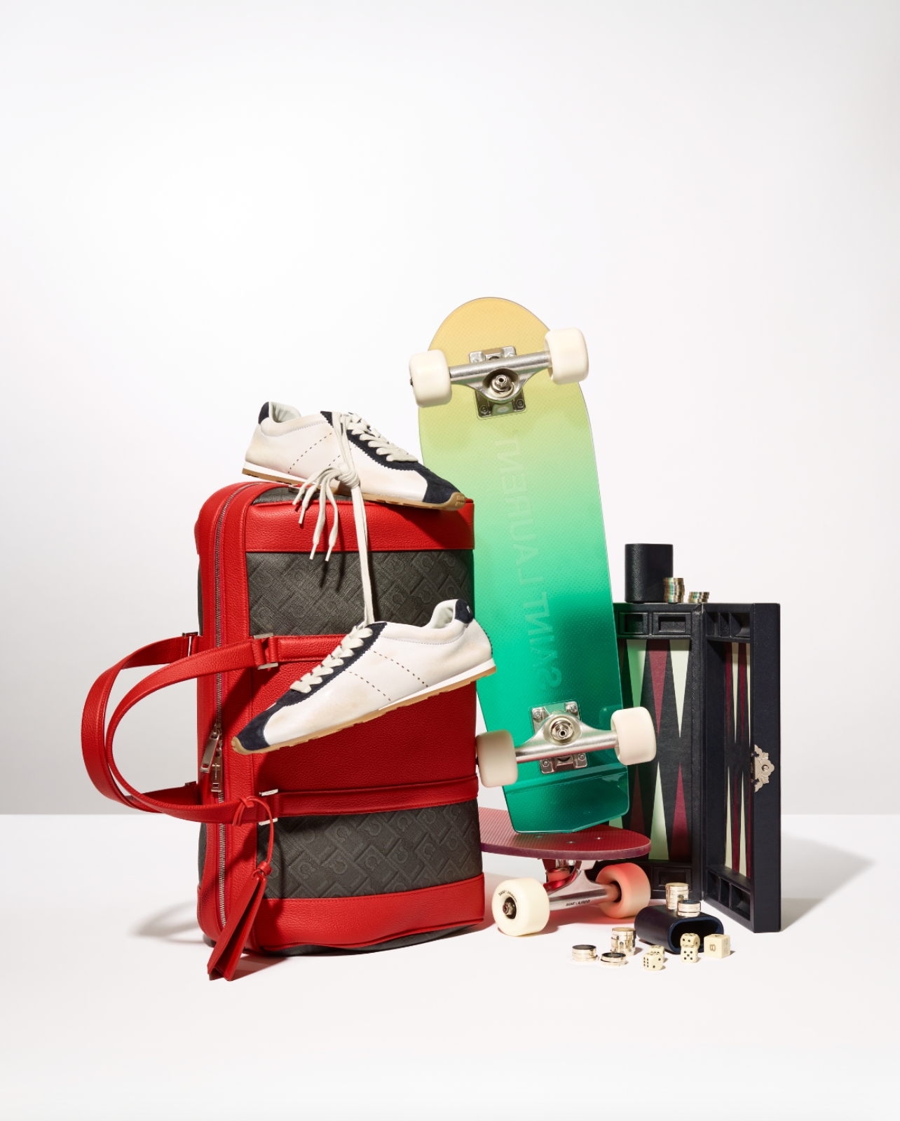 Gift Guide Image with a variety of items including skateboard, backgammon set and red duffle bag