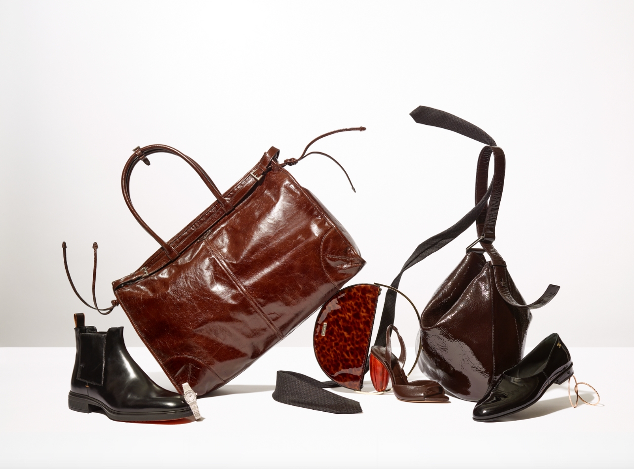 Gift Guide Image with a variety of items including brown and black shoes and bags