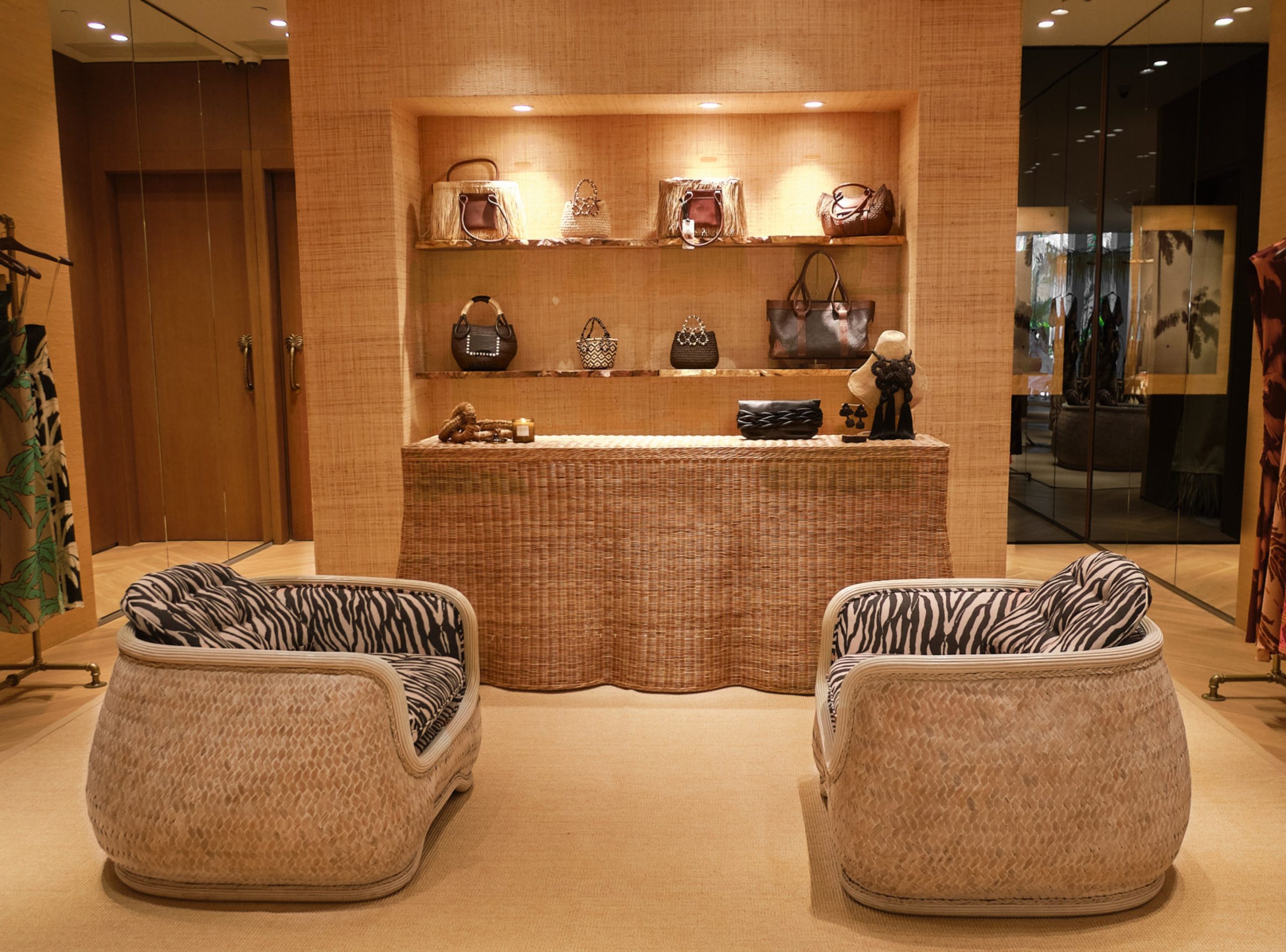 Johanna Ortiz new Bal Harbour Shops boutique with 2 wicker chairs and a wicker display with product