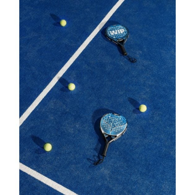 Aerial view of blue padel court with tennis balls and padels