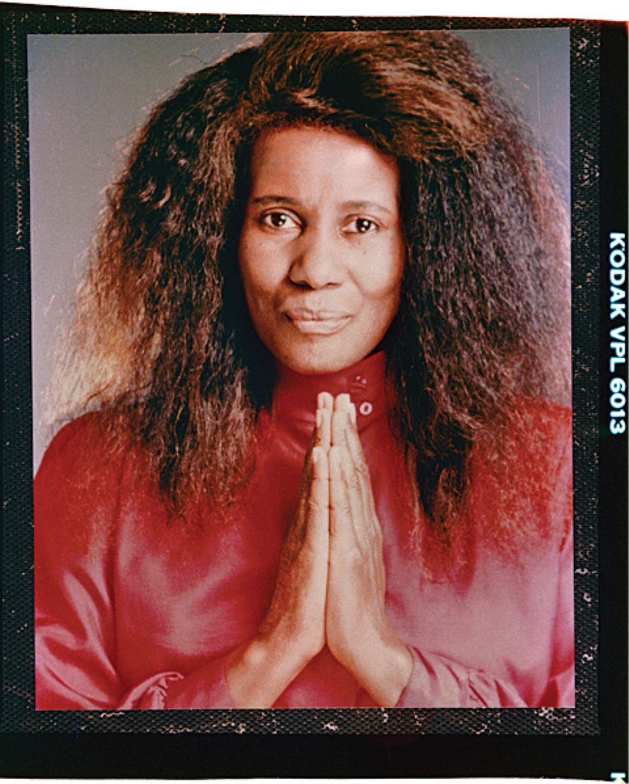 Portrait of Alice Coltrane wearing red top