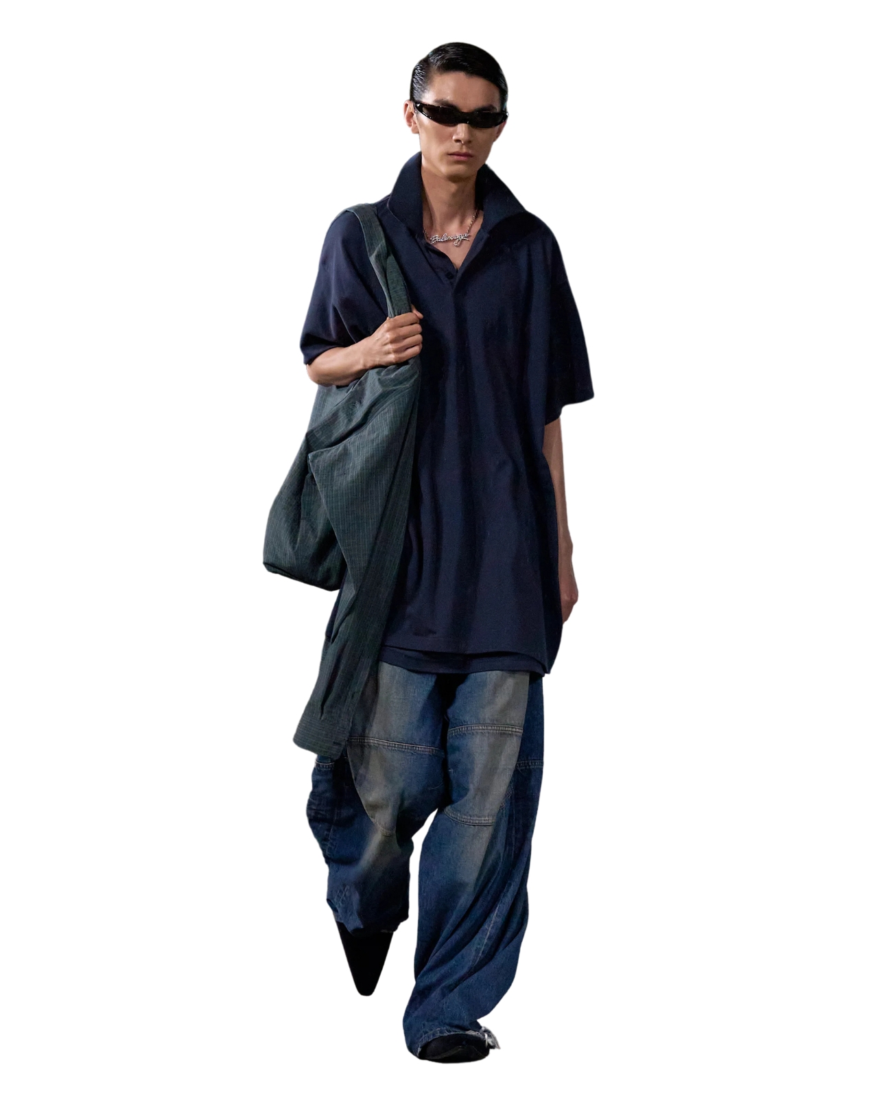 Balenciaga Model wearing navy polo shirt with denim jeans and black sunglasses