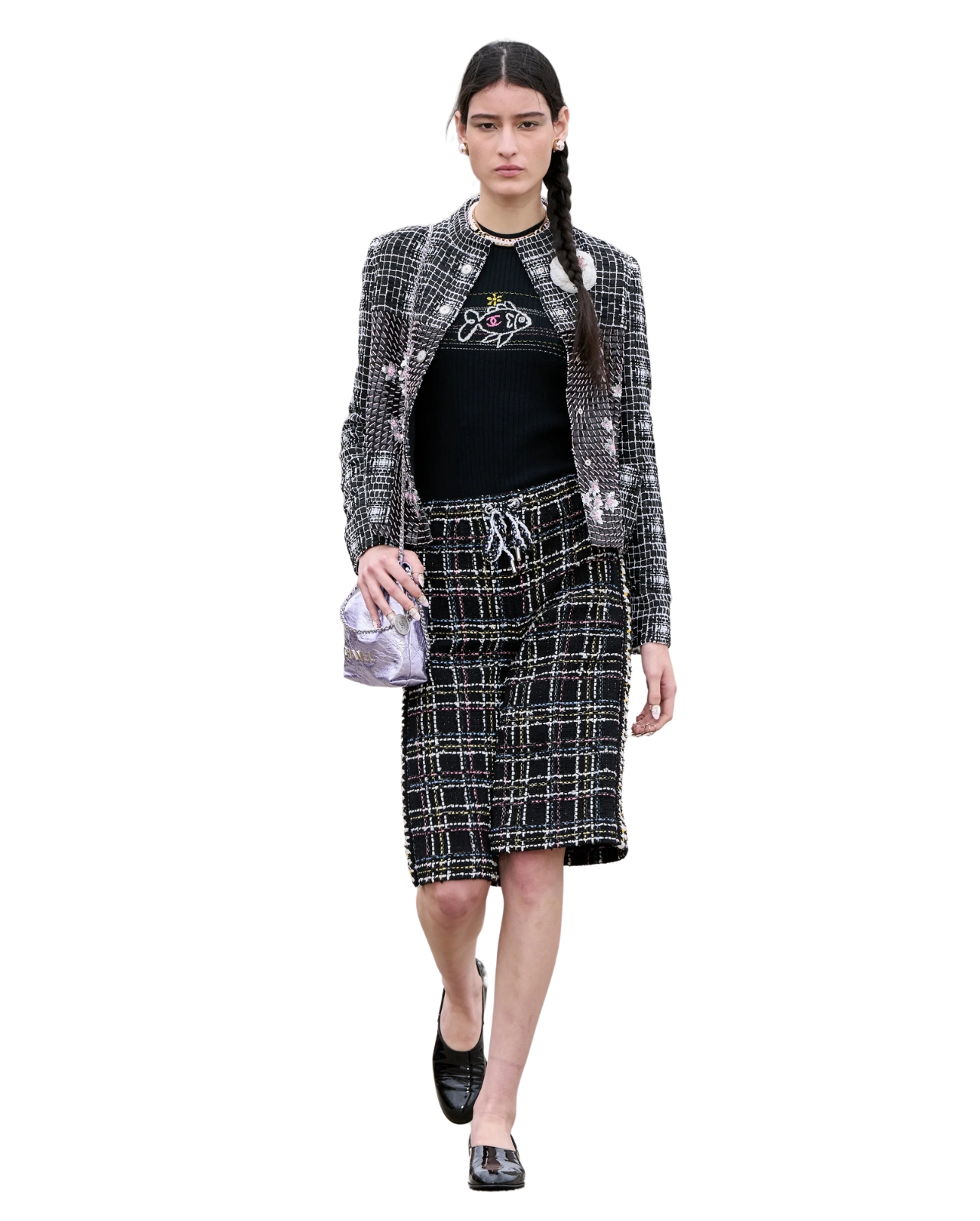 Chanel model wearing tweed jacket and shorts