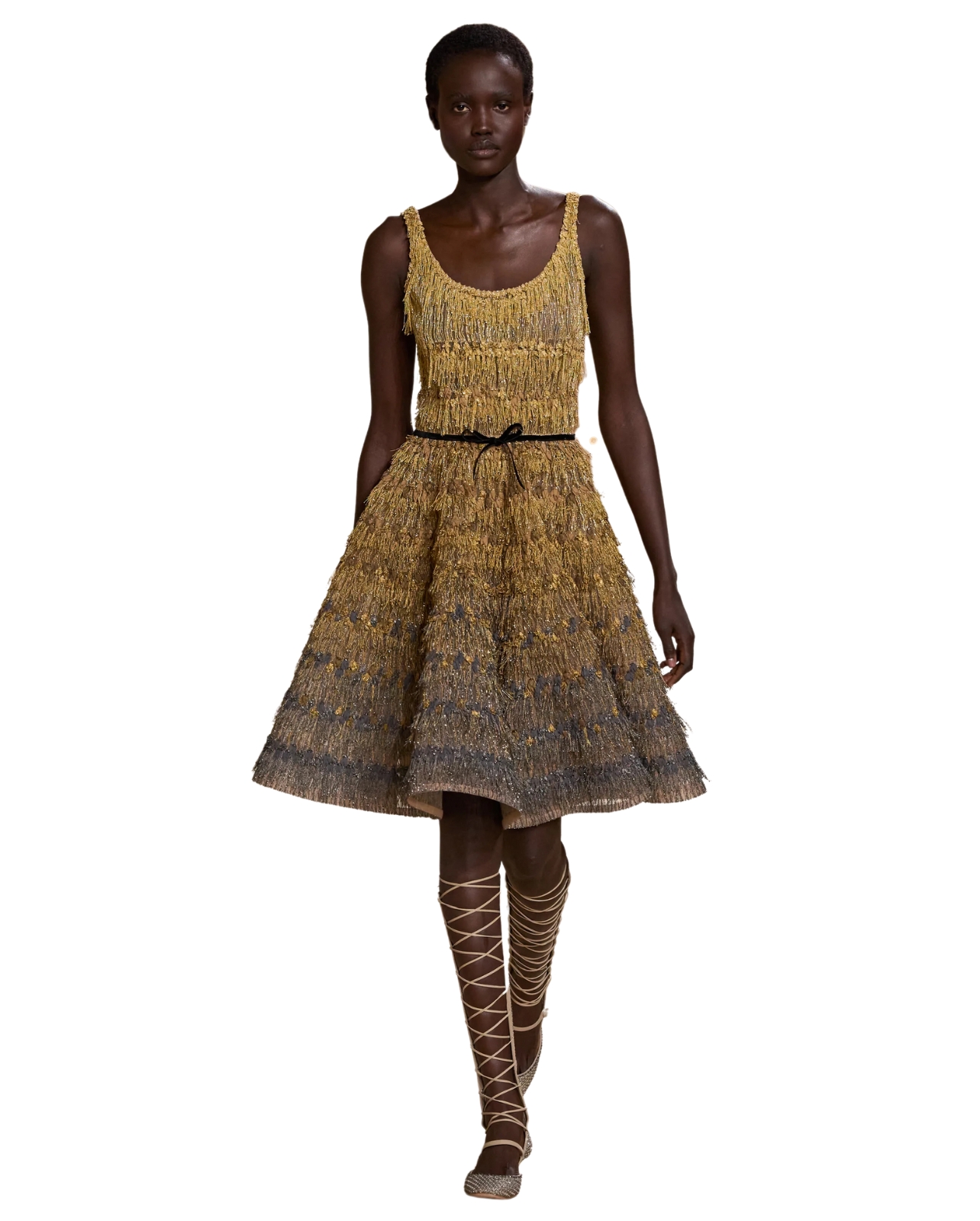 Dior model wearing a gold multi color embroidered dress with lace up ballet flats