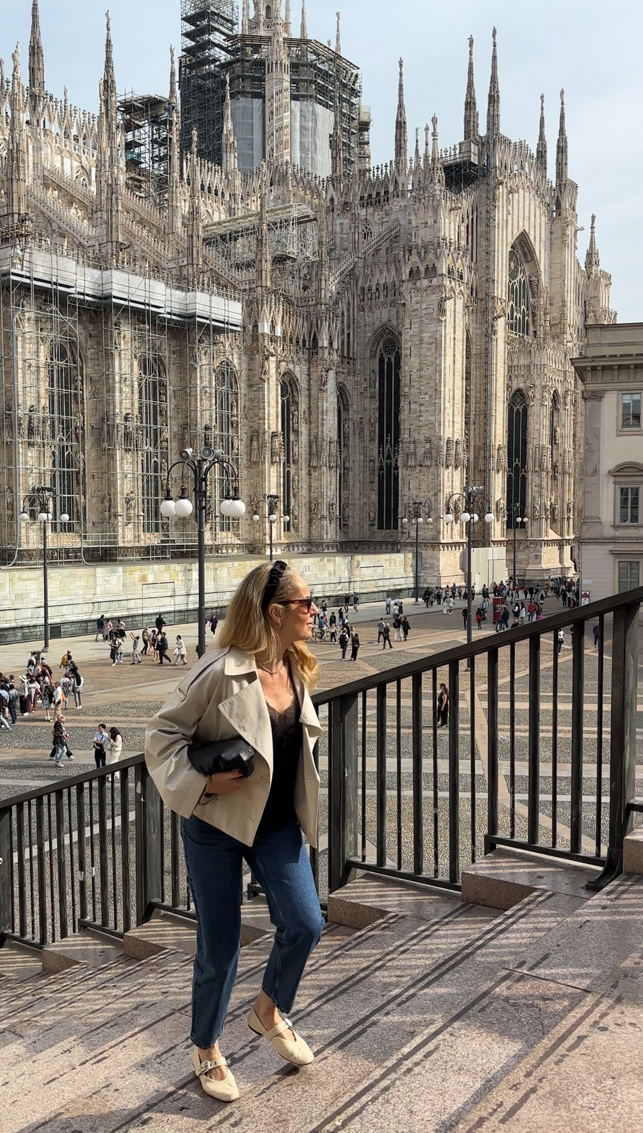 Portrait of Natasha Slater with Cathedral in the background walking up stairs