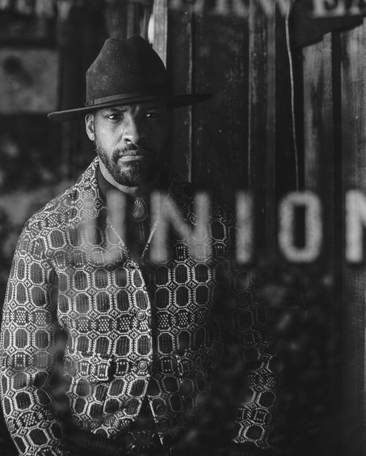 Black and white portrait of a man standing with a clear overlay that says union