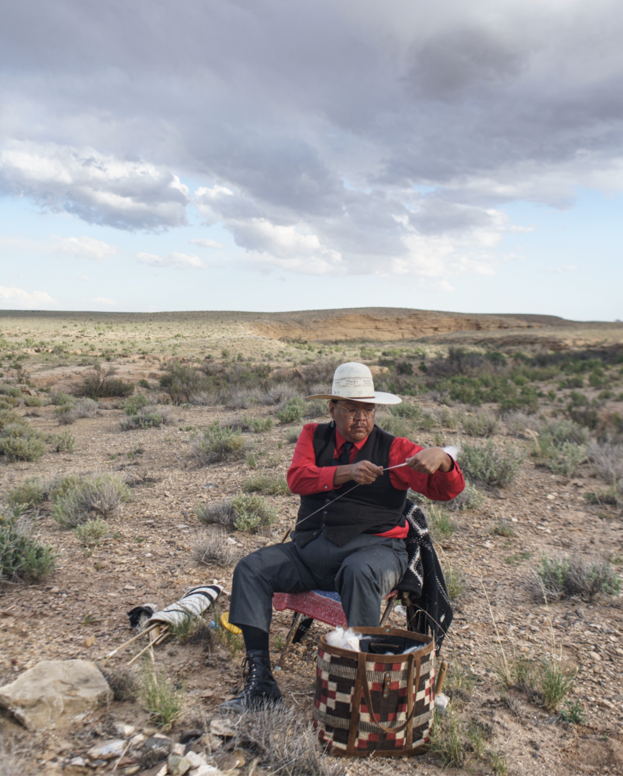 Zefren-M sitting in the middle of desert in red shirt