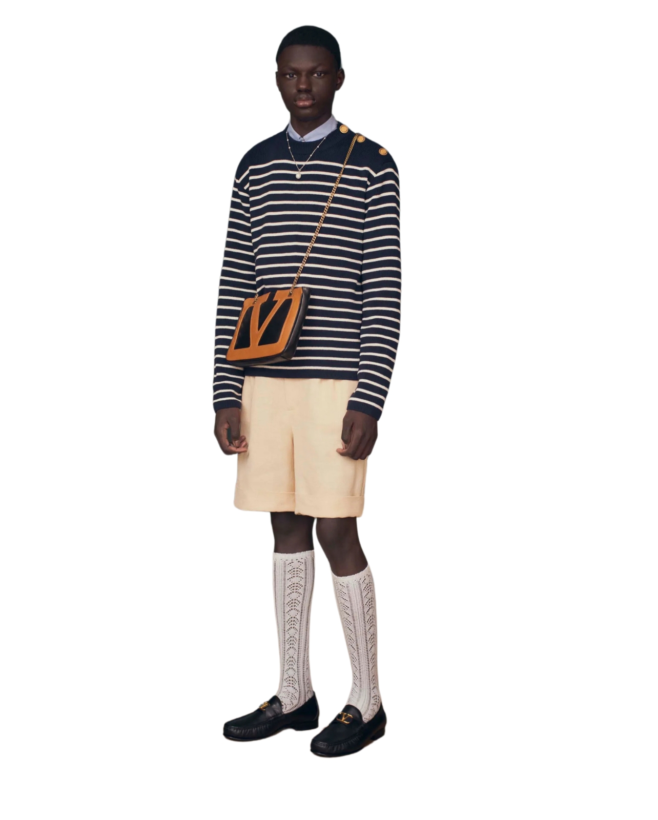 Valentino model wearings cream shorts and navy/white striped shirt