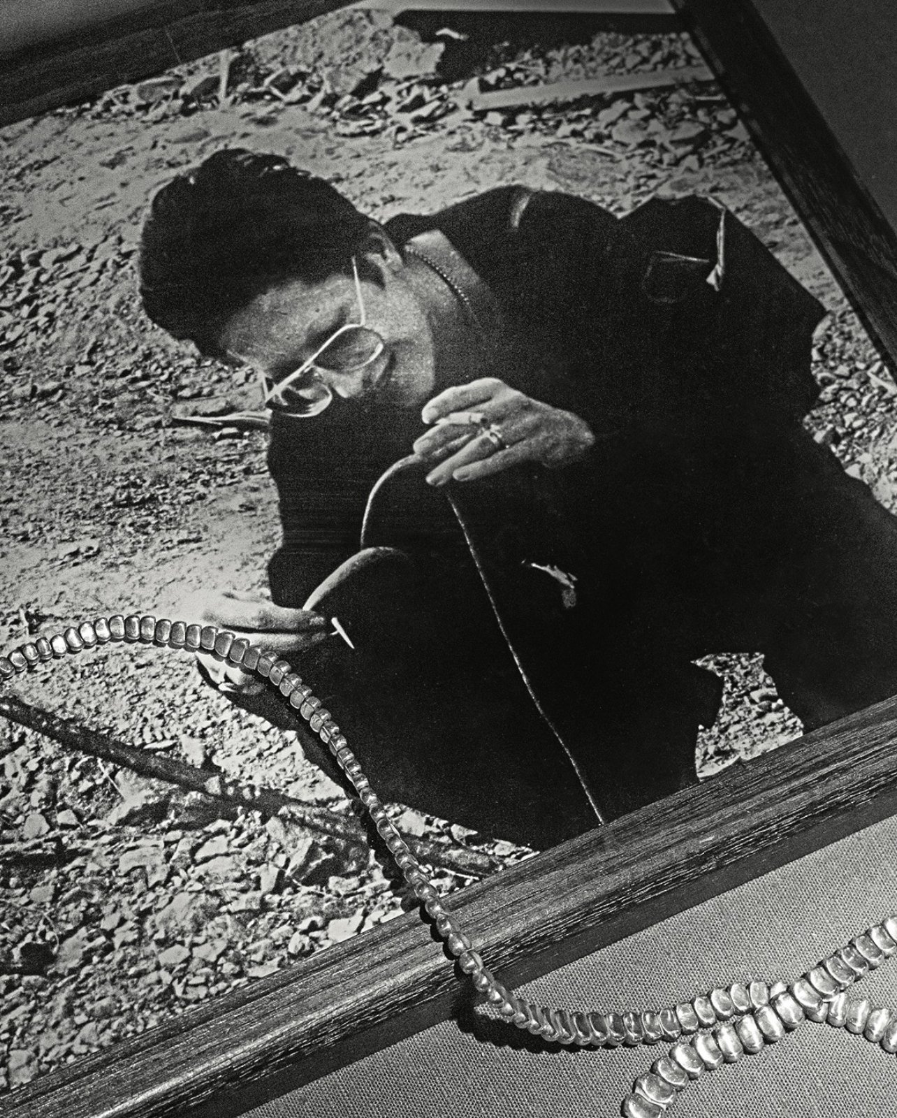 black and white photo of a woman with silver necklace across