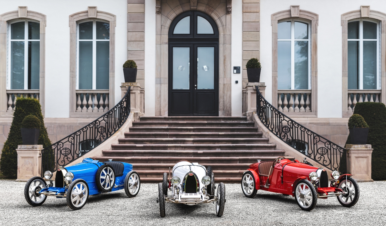 Three cards in blue, white and red, parked in front of home