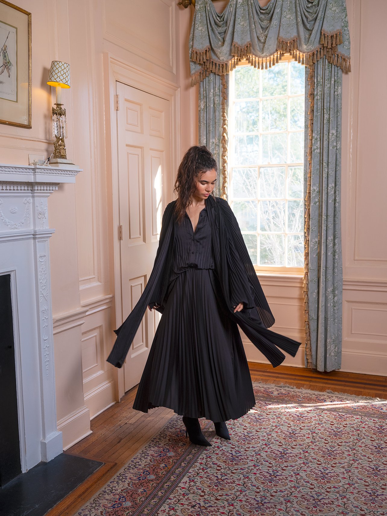 Model wearing an all black Balenciaga look in living room